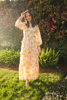 Jennafer Grace Amarillo Love maxi dress featuring vibrant yellow fabric and flowing design, perfect for casual or special occasions.