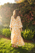 Jennafer Grace Amarillo Love Maxi Dress featuring a flowing yellow fabric and elegant design for summer wear.