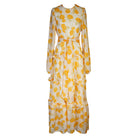 Jennafer Grace Amarillo Love Maxi Dress displayed flat, showcasing the flowy yellow fabric, V-neckline, and sleeveless design.