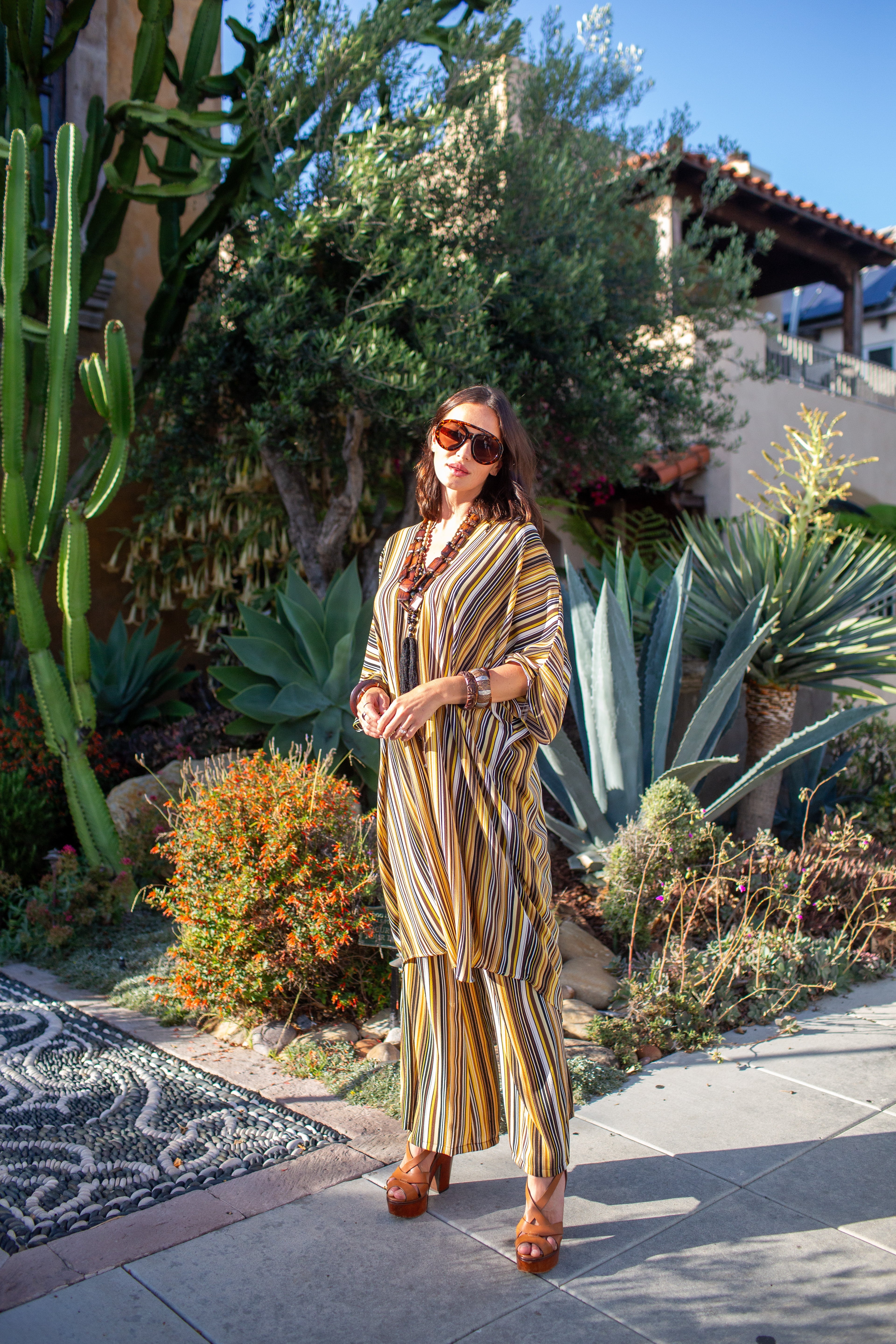 Bank-striped tunic caftan set with matching palazzo pants by Jennafer Grace, featuring flowing fabric and relaxed fit.