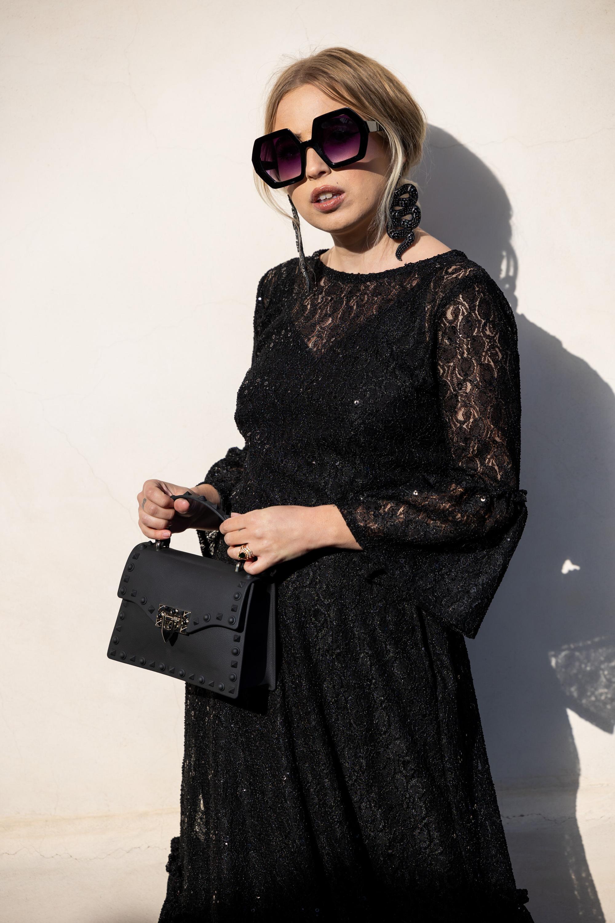 Black sequin lace ruffle dress by Jennafer Grace with intricate lace details and elegant ruffle accents.