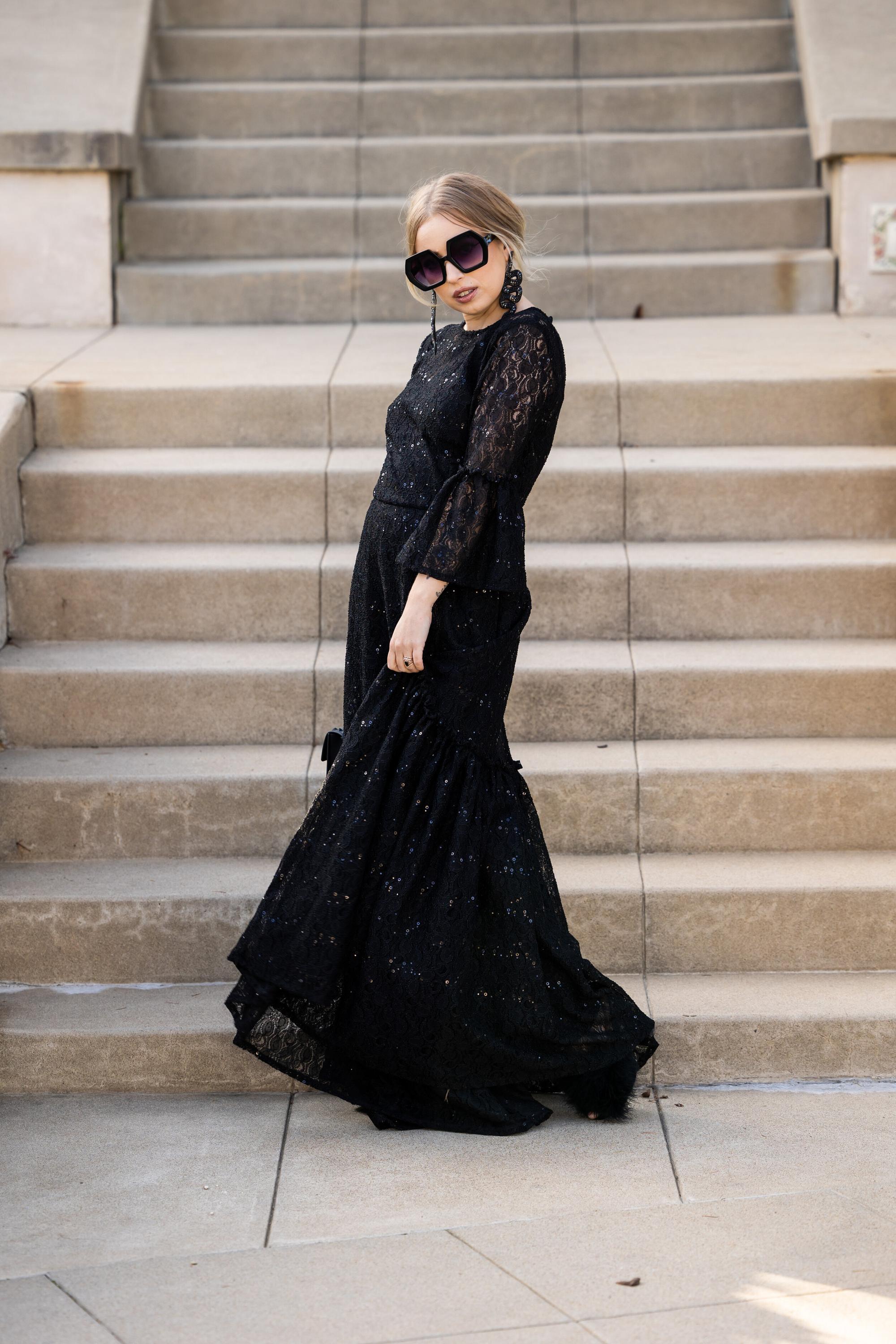 Black sequin lace ruffle dress by Jennafer Grace featuring intricate lace, shimmering sequins, and layered ruffle details.