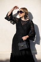 Black sequin lace ruffle dress by Jennafer Grace featuring intricate lace, shimmering sequins, and layered ruffle details.