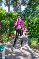 Jennafer Grace Planet Queen faux fur jacket in vibrant monster pink, displayed on a hanger with a soft textured background.