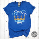 Kansas City Fountain Crown short sleeve graphic tee by The Graphic Tee, featuring city fountain and crown design on black fabric.