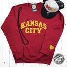 Dark red Kansas City gold glitter applique crewneck sweatshirt by The Graphic Tee, featuring a stylish Kansas City graphic design.