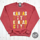 Kansas City multi-pattern letters heather sport scarlet crewneck sweatshirt, casual sportswear from The Graphic Tee.