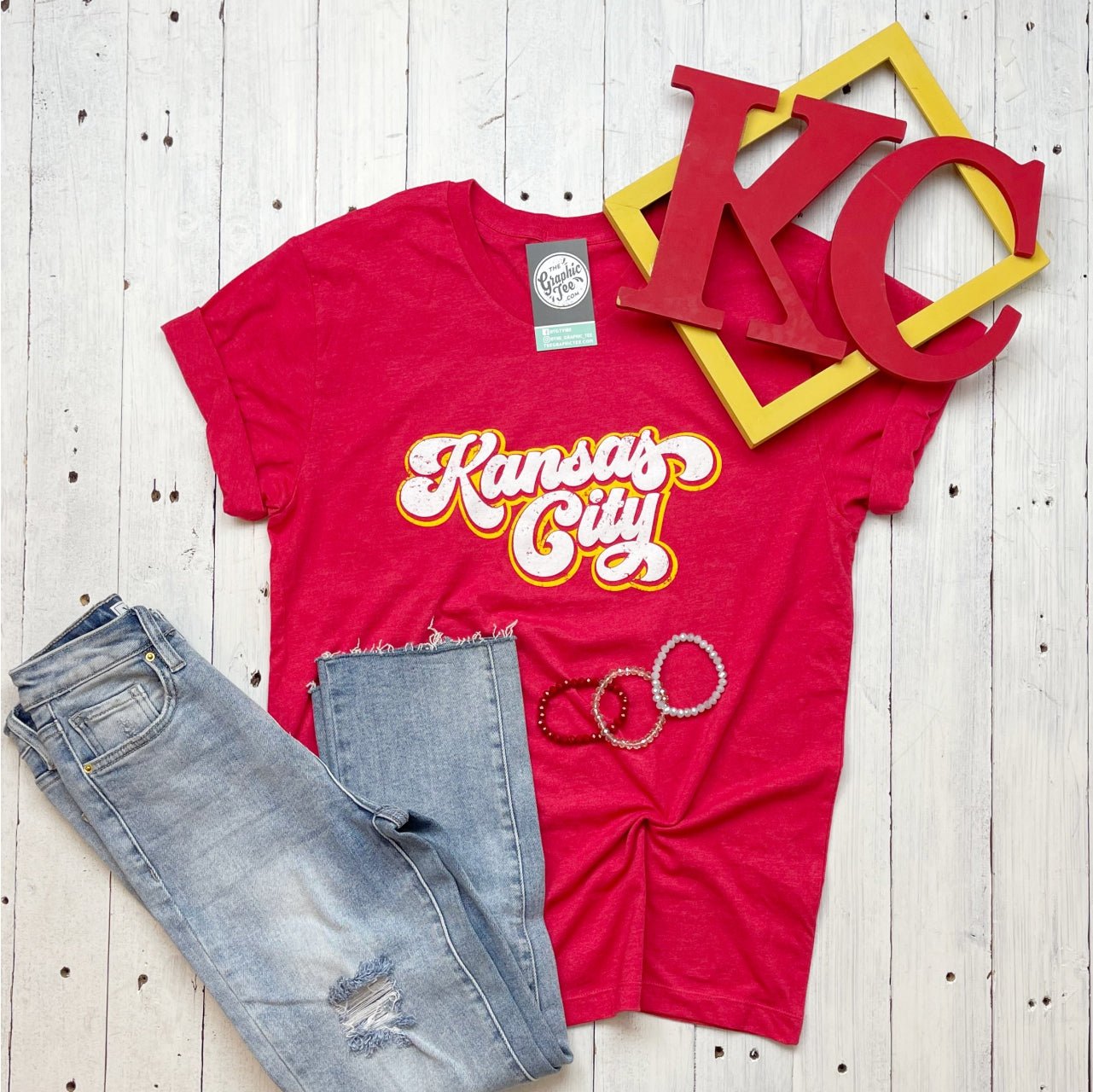 Kansas City Retro Cursive Crewneck Unisex Short Sleeve Graphic Tee by The Graphic Tee, featuring vintage Kansas City design.
