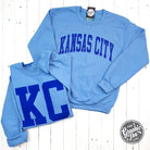 Reversible Carolina Blue Kansas City crewneck sweatshirt by The Graphic Tee, featuring casual, comfortable fabric and Kansas City graphics.