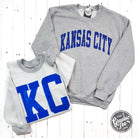 Kansas City Royal Blue Ink reversible sport grey crewneck sweatshirt by The Graphic Tee, showing front and back views.