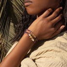 Womens amethyst infinity charm bracelet from Karma and Luck with purple gemstone beads and silver infinity charm.