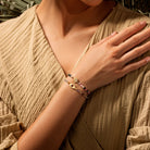Gold plated Lotus Blossom bracelet with tourmaline stones, designed for women by Karma and Luck, featuring intricate floral details.