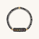 Karma and Luck women's Swarovski Crystal Hematite Chakra bracelet featuring polished beads and a delicate design.