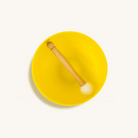 Yellow Solar Plexus Chakra singing bowl from Karma and Luck, used as home decor with intricate designs and a polished finish.