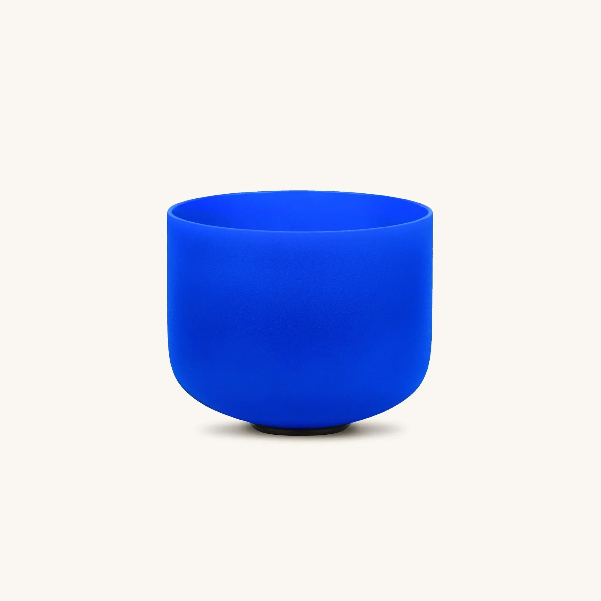 Blue throat chakra singing bowl from Karma and Luck, used as home decor, featuring intricate designs and a polished finish.