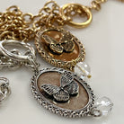 Katia Designs butterfly choker necklace in antique gold with engraved “She Believed She Could” text, lightweight jewelry accessory.