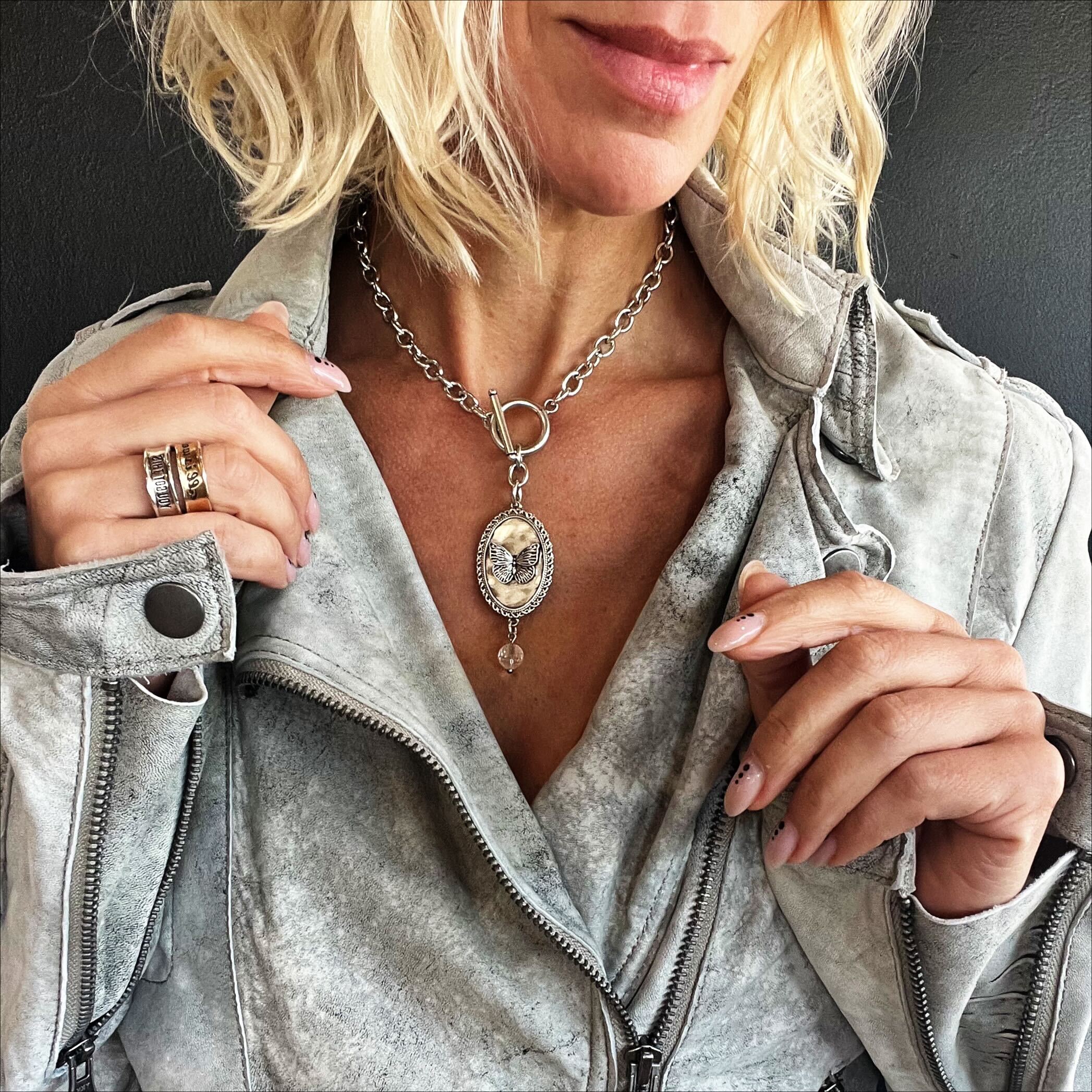Katia Designs butterfly choker necklace in antique gold with engraved "She Believed She Could" inscription, stylish and elegant accessory.