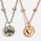Dainty antique gold necklace with black lip pearl and "I Am Enough" heart pendant by Katia Designs, close-up view.