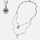 Dainty antique gold necklace with black lip pearl and "I Am Enough" heart charm by Katia Designs