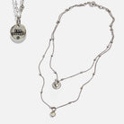 Dainty antique gold necklace by Katia Designs with a black lip pearl and an "I Am Enough" heart pendant.