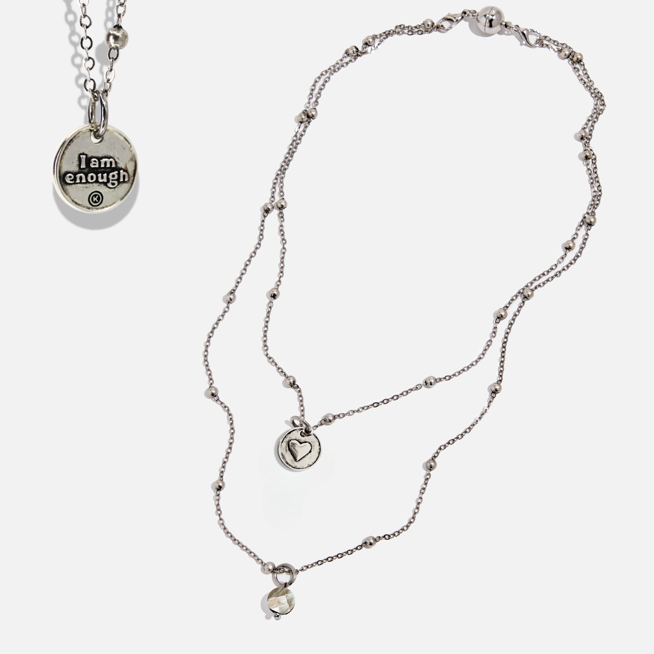 Dainty antique gold necklace by Katia Designs with a black lip pearl and an "I Am Enough" heart pendant.