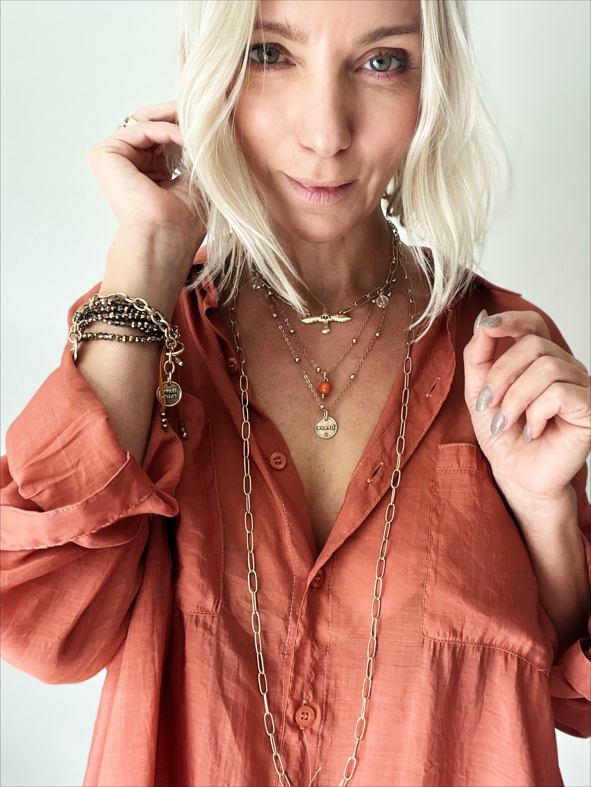 Dainty antique gold necklace by Katia Designs with black lip pearl and heart pendant, showcasing elegant jewelry design.