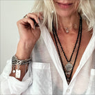 Dainty gold necklace by Katia Designs featuring a black lip pearl pendant with an "I Am Enough" heart charm.