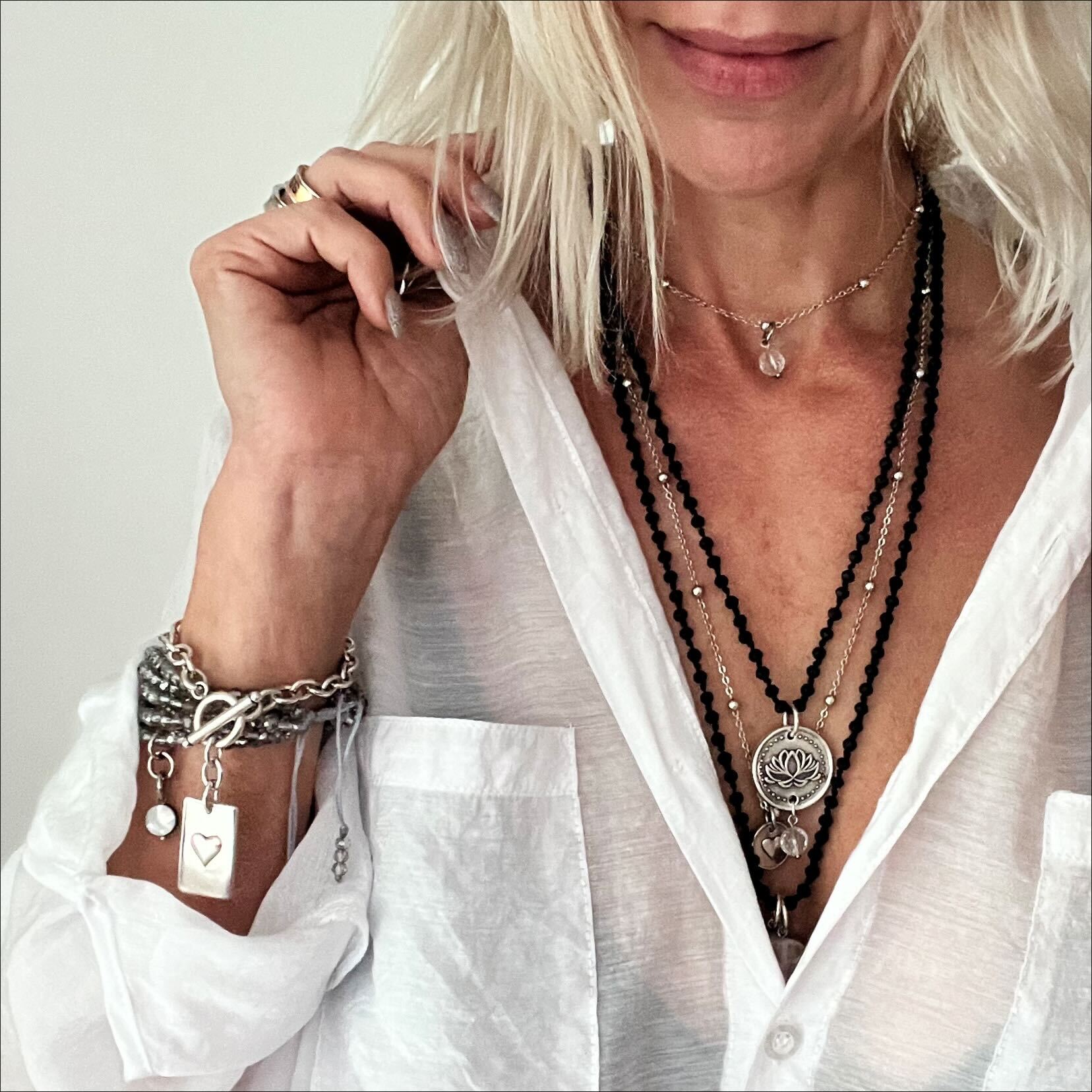 Dainty gold necklace by Katia Designs featuring a black lip pearl pendant with an "I Am Enough" heart charm.
