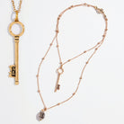 Dainty antique gold "I Am Free" key necklace by Katia Designs, featuring a delicate pendant on a fine chain.