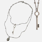 Katia Designs dainty antique gold "I Am Free" key necklace with delicate chain and small key pendant.