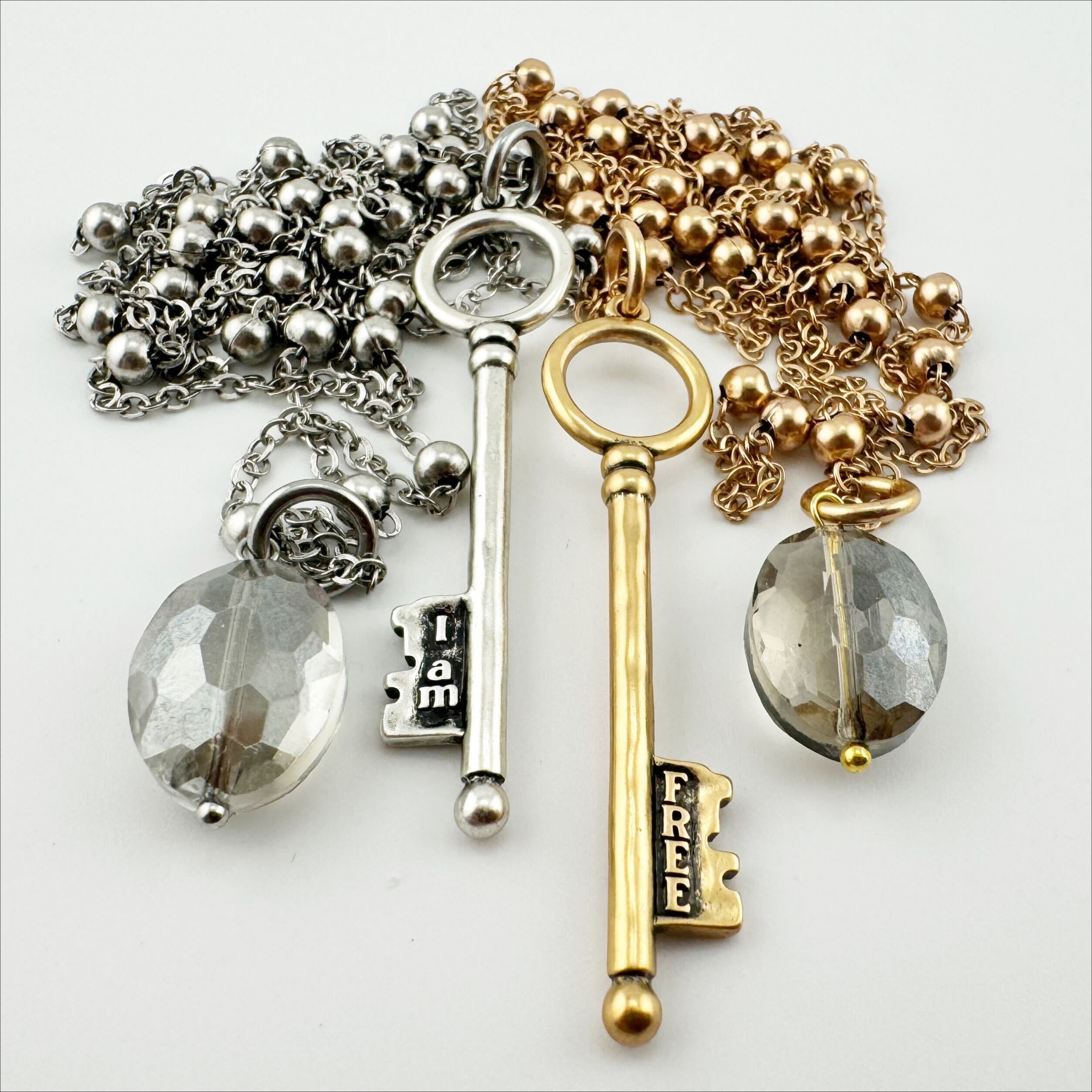 Katia Designs dainty antique gold "I Am Free" key necklace, delicate jewelry with intricate key pendant on a fine chain.