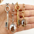 Dainty antique gold key necklace from Katia Designs with delicate chain and intricate key pendant.