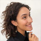 Katia Designs small stone drop earrings with antique gold finish and clear crystal quartz accents, elegant jewelry accessory.