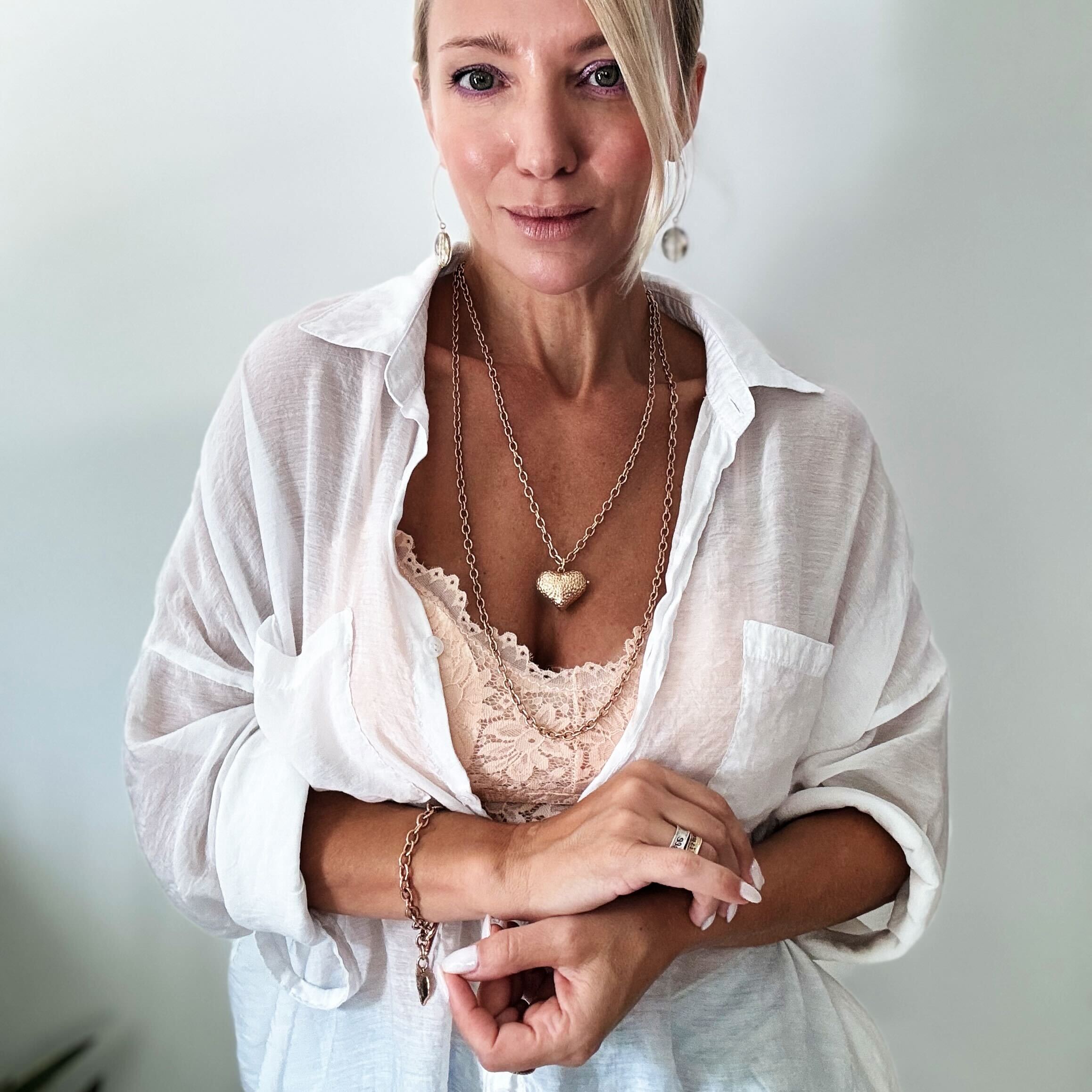 Katia Designs Follow Your Heart Heart Locket Essential Necklace in antique gold, featuring a delicate heart-shaped pendant.
