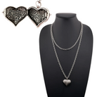 Katia Designs antique gold Follow Your Heart heart locket essential necklace hanging on a chain with engraved details