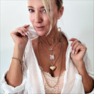Katia Designs Follow Your Heart Heart Locket Essential Necklace in antique gold with a delicate heart-shaped pendant.