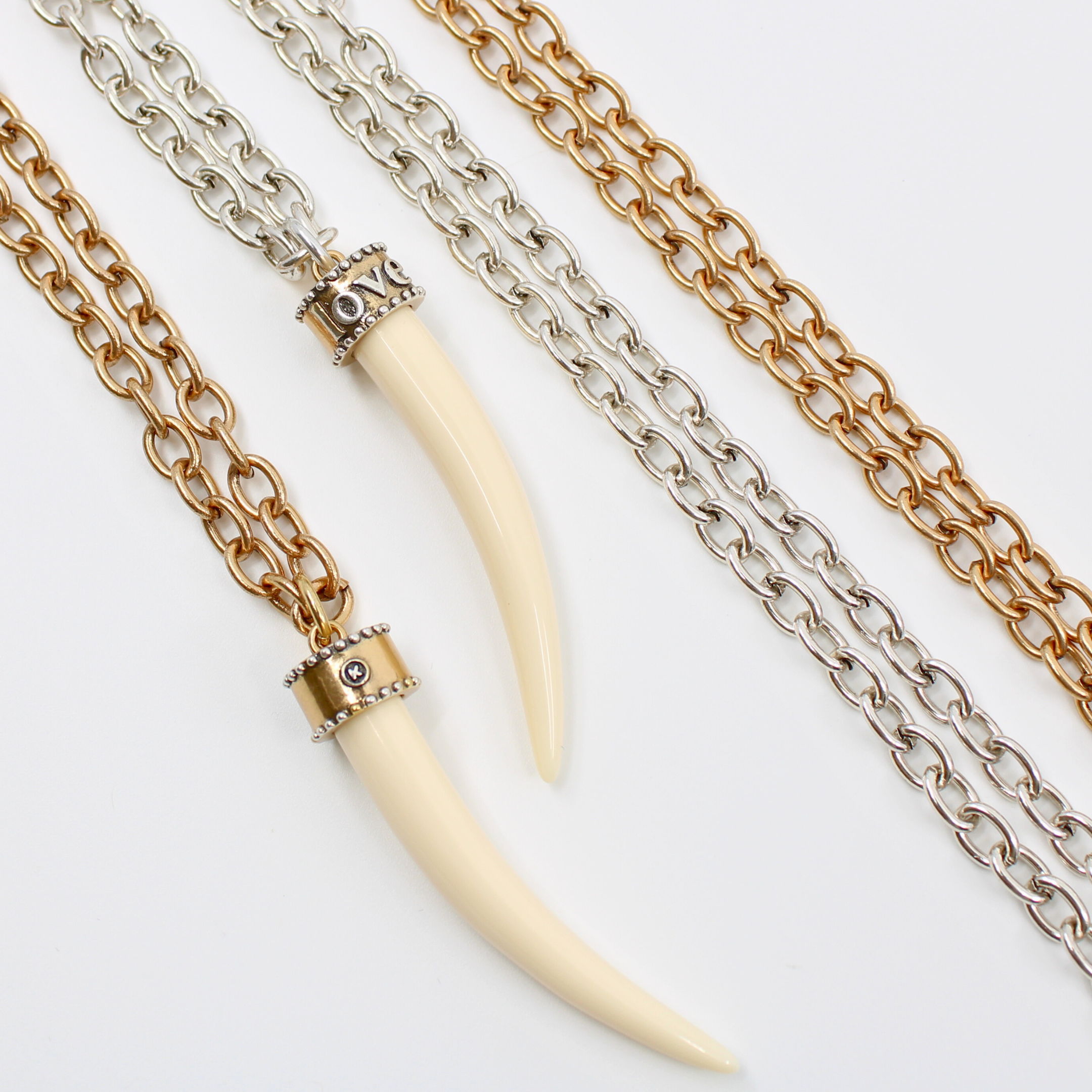 Katia Designs Love Tusk Essential Necklace in antique gold featuring a love-shaped tusk pendant on a delicate chain.