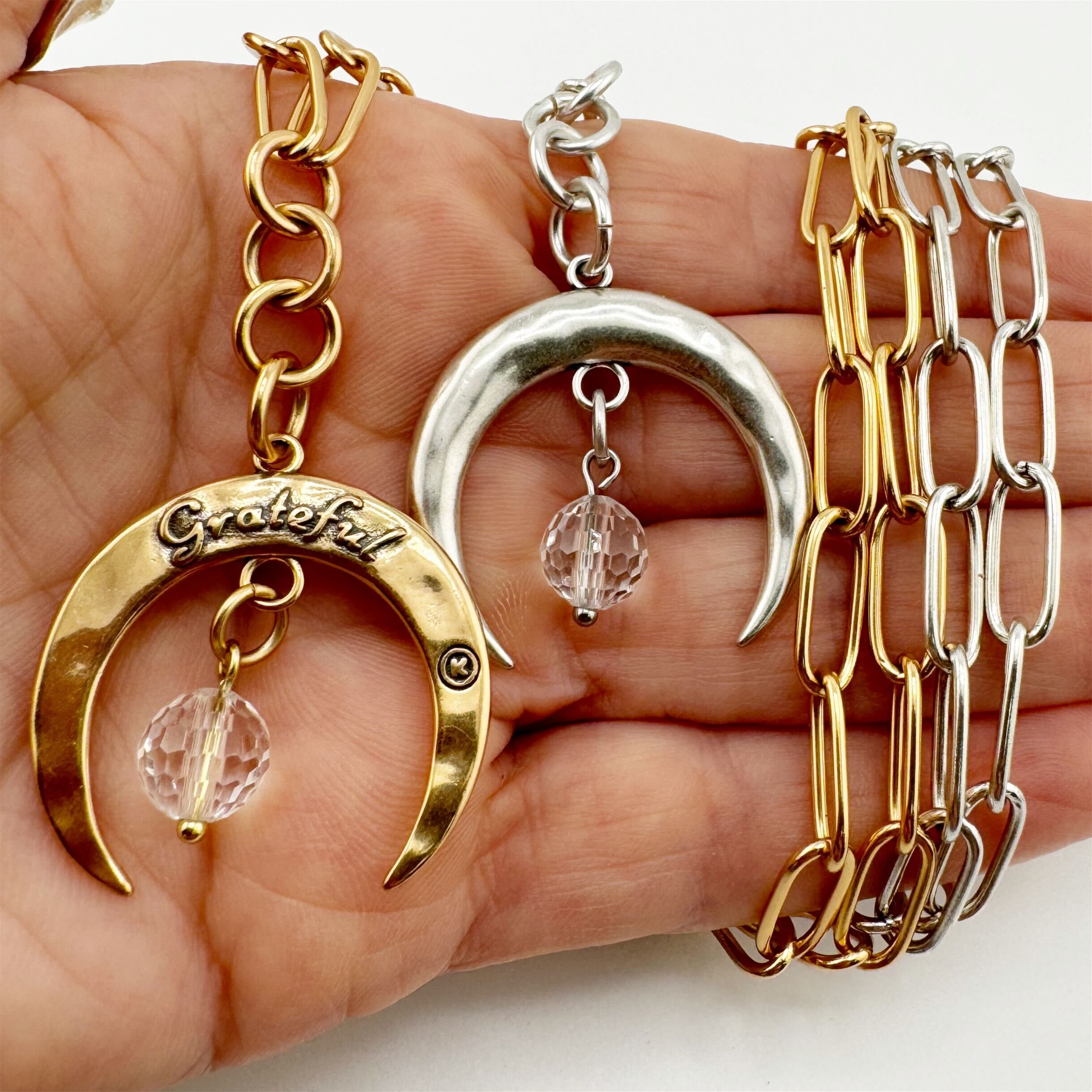 Katia Designs antique gold crescent moon klink necklace with intricate moon-shaped pendant and textured chain.