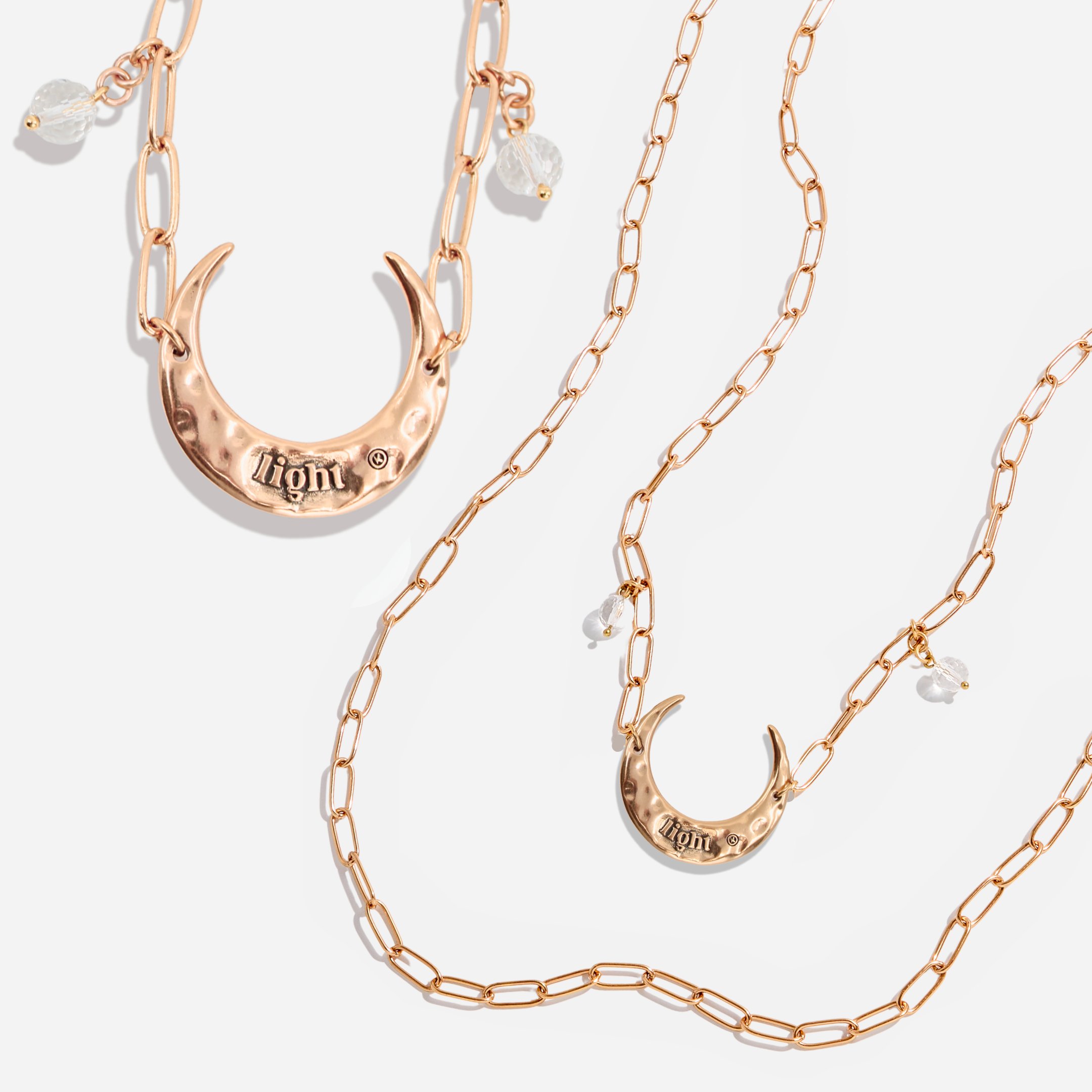 Katia Designs light antique gold crescent moon long chain necklace with delicate pendant and elegant design.