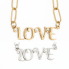 Katia Designs antique gold Love long chain necklace with intricate links and pendant, elegant jewelry for stylish occasions.