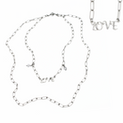 Antique gold long chain necklace by Katia Designs featuring a delicate love pendant, styled with casual and elegant outfits.