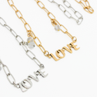 Katia Designs antique gold long chain necklace with a love pendant, featuring elegant metal links and a stylish, modern design.