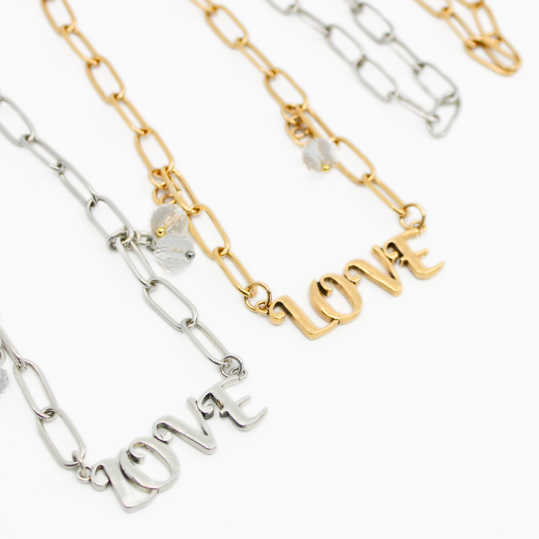Katia Designs antique gold long chain necklace with a love pendant, featuring elegant metal links and a stylish, modern design.