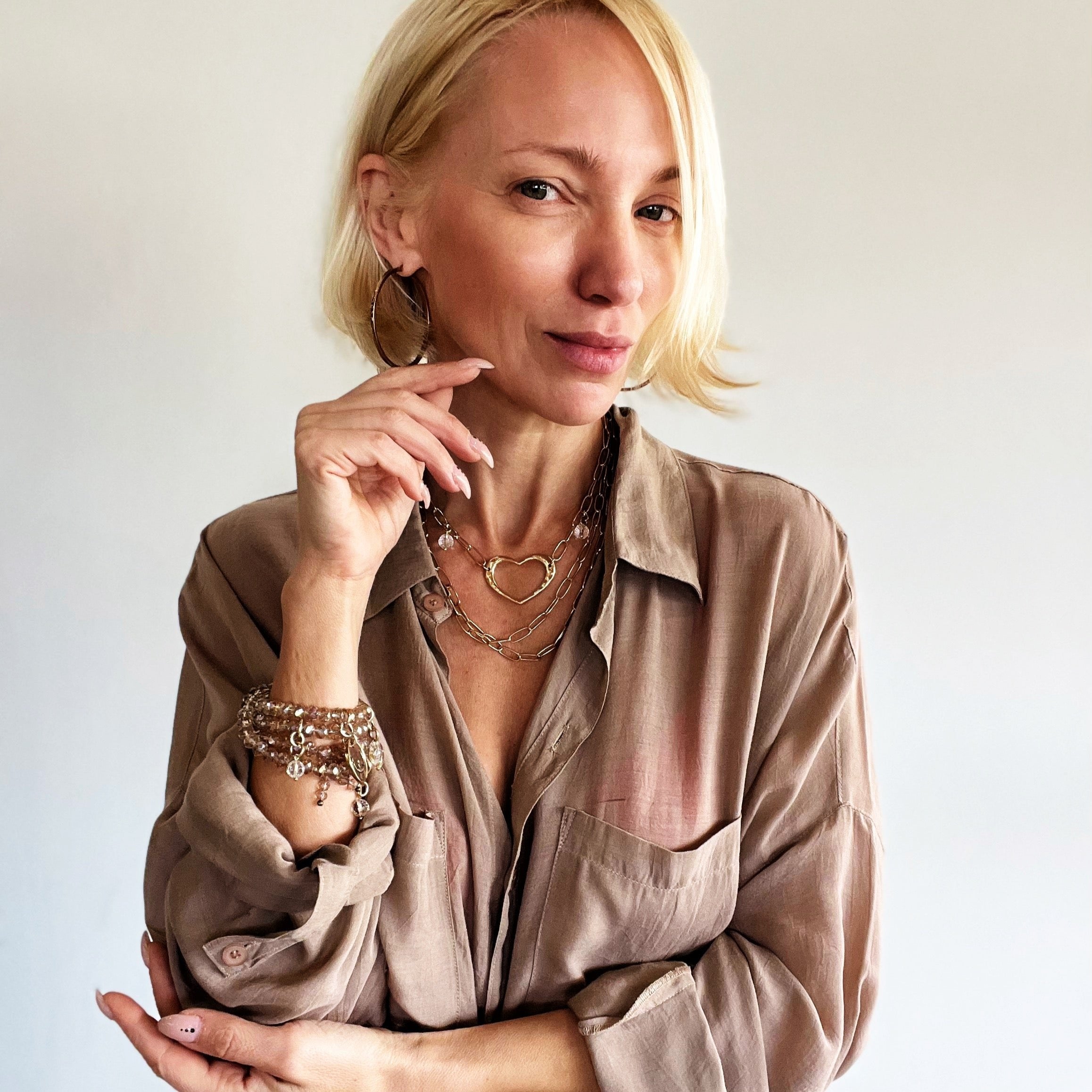 Katia Designs long chain necklace with an open heart pendant in antique gold, elegant jewelry accessory for women