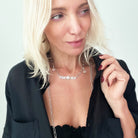 Katia Designs Manifestor long chain necklace in antique gold with intricate links, stylish and elegant accessory for any outfit.