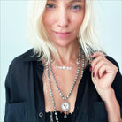 Katia Designs Manifestor long chain necklace in antique gold with intricate links and elegant design, hanging gracefully.