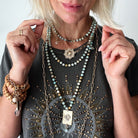 Katia Designs antique gold starburst long chain necklace with imperfect, handcrafted pendant, elegant and stylish jewelry accessory.