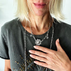 Katia Designs antique gold starburst long chain necklace with a handcrafted, imperfect design featuring a delicate pendant.