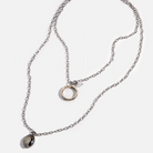 Katia Designs original antique gold necklace with clear AB crystal accents and a ring-shaped pendant engraved with "I Welcome Miracles".