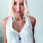 Katia Designs original antique gold necklace with clear AB crystals and a ring pendant inscribed "I Welcome Miracles."